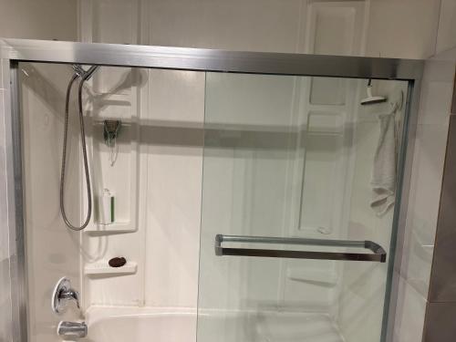 a shower with a glass door in a bathroom at Oshawa Duplex in Oshawa