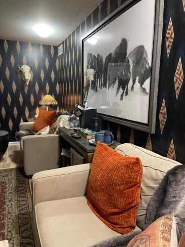a living room with a couch and a picture on the wall at Yellow Daisy Bed and Breakfast in Dahlonega
