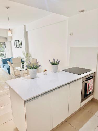 a white kitchen with a white counter top at Foster Palermo Heras Suites in Buenos Aires