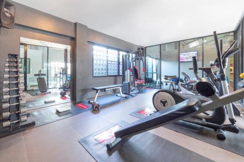 a gym with several treadmills and cardio equipment at OYO 75382 Chonburi Hotel in Chon Buri