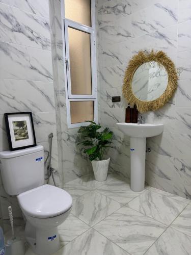 a white bathroom with a toilet and a sink at Cozy apartment Heart of medina Tetuan in Tetouan