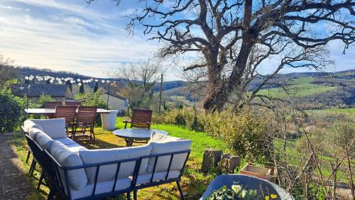 a patio with a couch and chairs and a table at Appartamento Holly House in Radda in Chianti