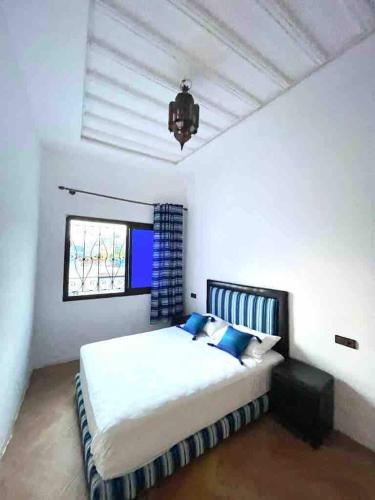 a bedroom with a large bed and a window at Blue Vista 2 in Chefchaouen