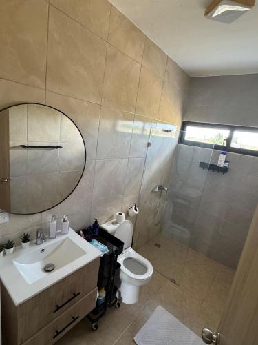 a bathroom with a toilet and a sink and a shower at Terraza Caribeña in Bayahibe