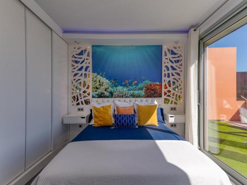 a bedroom with a fish tank mural on the wall at Chalet in Maspalomas with Heated Pool in San Bartolomé de Tirajana