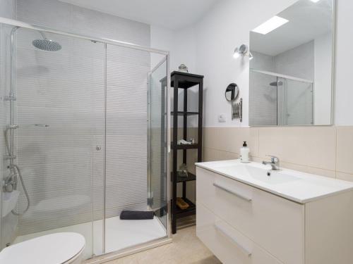a bathroom with a shower and a toilet and a sink at Apartment in Mogán Playa near the Beach in Mogán