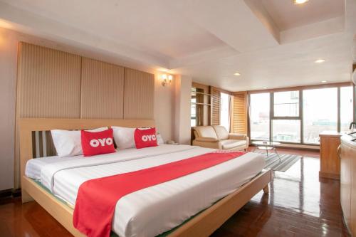 una camera da letto con un grande letto con cuscini rossi di Hotel Win Long a Bangkok
