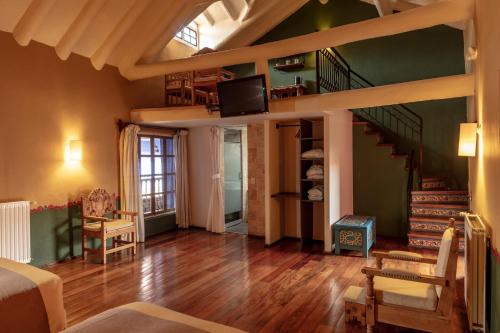 a living room with a loft with a staircase at Tambo del Arriero Hotel Boutique in Cusco