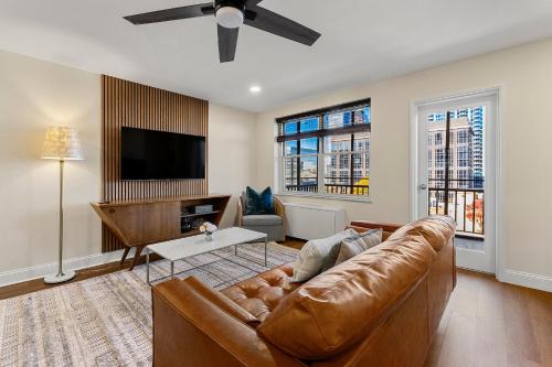 a living room with a couch and a flat screen tv at Stylish 1-Bedroom Condo Downtown Atlanta in Atlanta