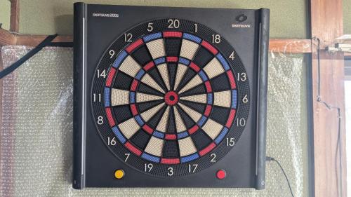a dart board is hanging on a wall at Asoviva in Anan
