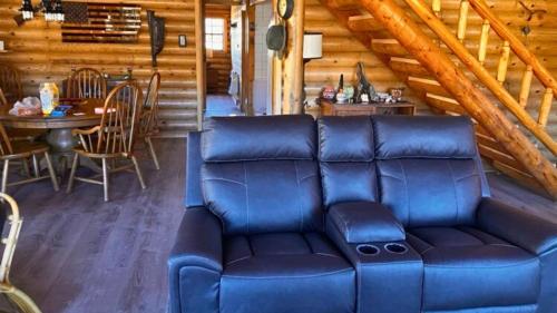 a living room with a blue couch in a cabin at Breathe Inn Off Grid Cabin on 40 Acres in Bisbee