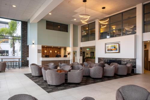 a lobby of a hospital with chairs and a fireplace at Heartland Hotel Auckland Airport in Auckland