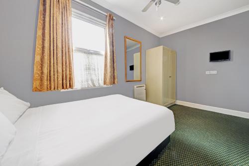 Postel nebo postele na pokoji v ubytování OYO Bostons Manor Hotel, Hanwell London