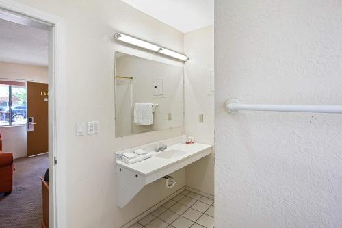 a bathroom with a sink and a mirror at OYO Hotel Yuma AZ - I-8 US-95 in Yuma