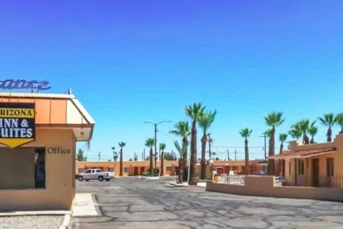 an empty street with palm trees and a building at OYO Hotel Yuma AZ - I-8 US-95 in Yuma