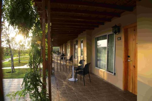a porch with chairs and tables on a building at Casa Andina Standard Chincha in Chincha Alta