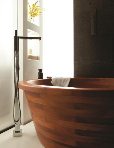 a wooden bath tub in a bathroom with a window at The Langham, Shanghai, Xintiandi in Shanghai