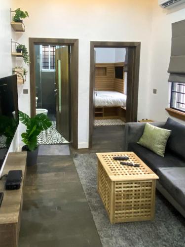 a living room with a couch and a table at Petite Stylish 1Bed Apt Courtyard Lekki1 in Lekki Phase 1
