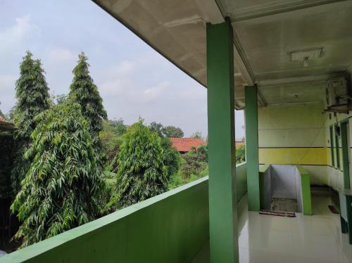 a view of trees from the balcony of a building at OYO 90333 Wisma Tenang Jaya Syariah in Majalengka