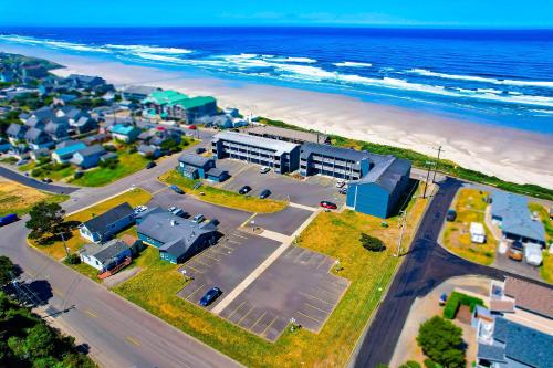 an aerial view of a beach with buildings and the ocean at OYO Waves Hotel Newport OR - NYE Beach in Newport