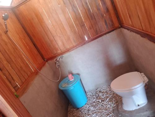 a small bathroom with a toilet and a trash can at Marlina Homestay in Fam