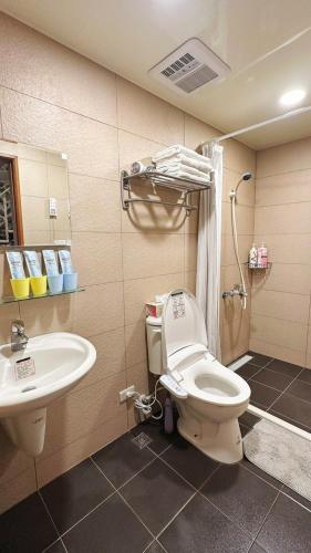 a bathroom with a toilet and a sink at 九份輕旅民宿 in Jiufen