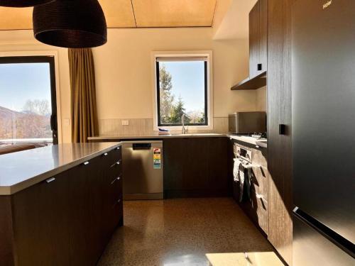a large kitchen with a sink and a stove at The Peaks - Lake Tekapo in Lake Tekapo