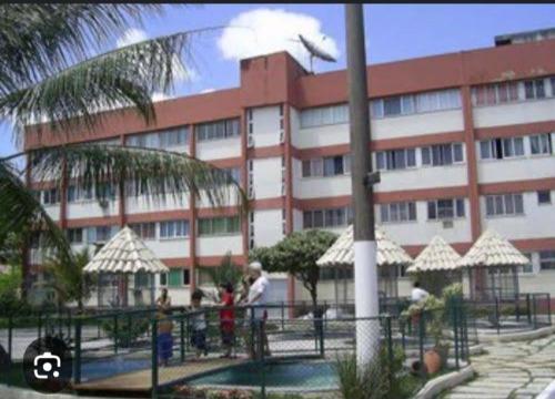 a large building with people standing in front of it at Rota das Praias in Vila Velha