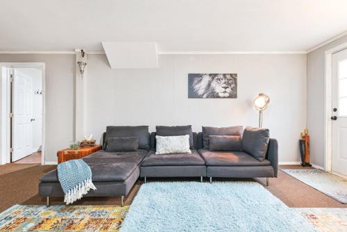 a living room with a couch and a rug at Cozy basement apartment in Fayetteville