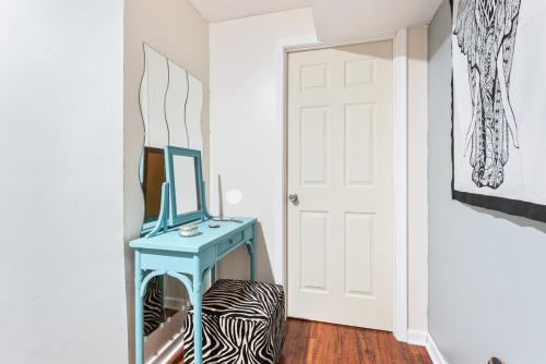 a room with a blue table and a mirror at Cozy basement apartment in Fayetteville
