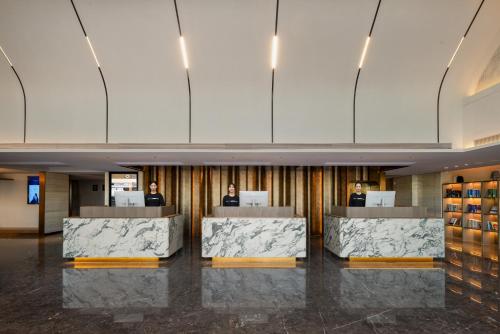 a lobby of a building with marble counters at Atour Hotel Guangzhou Railway Station University of Chinese Medicine - Complimentary Self-Service Laundry in Guangzhou