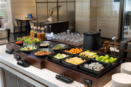 a buffet with many different types of fruits and vegetables at Atour Hotel Guangzhou Railway Station University of Chinese Medicine - Complimentary Self-Service Laundry in Guangzhou