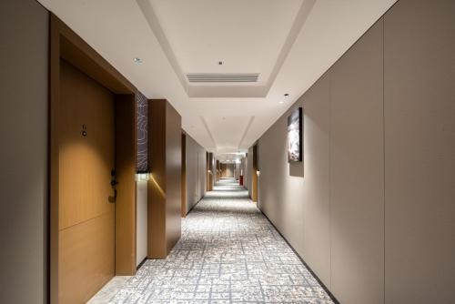 a corridor in a building with a long hallway at Atour Hotel Guangzhou Railway Station University of Chinese Medicine - Complimentary Self-Service Laundry in Guangzhou