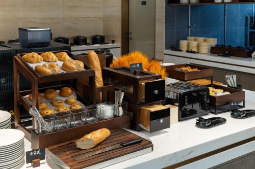 a display of bread and pastries on a counter at Atour Hotel Guangzhou Railway Station University of Chinese Medicine - Complimentary Self-Service Laundry in Guangzhou