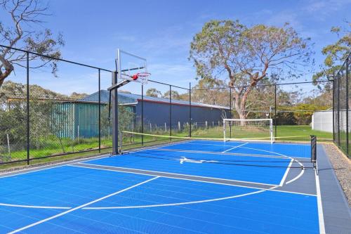 a tennis court with a basketball hoop on it at Homestead Pool House Private cabin w shared Spa Basketball court Heated Pool Minutes to Adventure Park and beaches in Wallington