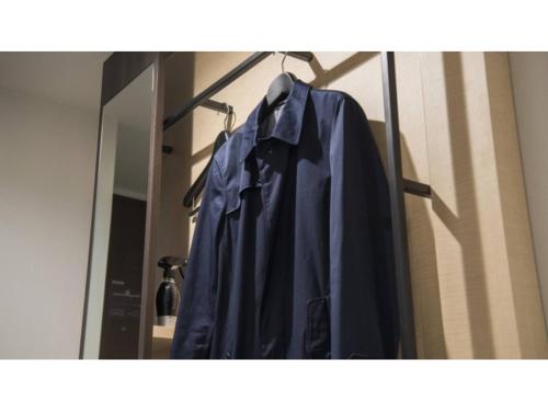 - un peignoir suspendu sur un portant devant un miroir dans l'établissement Tmark City Hotel Sapporo Odori - Vacation STAY 85621v, à Sapporo