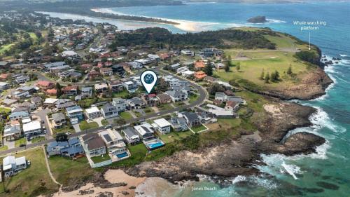 an aerial view of a town next to the ocean at Beachcomber in Kiama Downs
