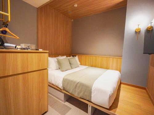 a bedroom with a large bed in a room at The GALA Hotel Umeda in Osaka