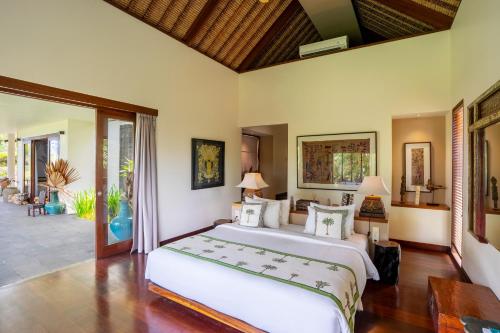a bedroom with a large bed in a room at Villa Palem in Tabanan