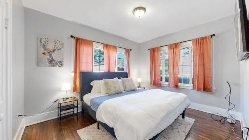 a bedroom with a bed and two windows at Chic Denver Family Retreat Free Parking & Prime Location in Denver