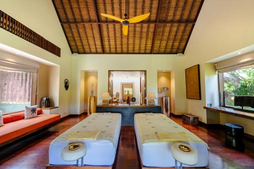 a living room with two beds and a couch at Villa Palem in Tabanan