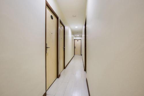an empty hallway with white walls and a long corridor at Hotel O Taj (seksyen 7) in Shah Alam