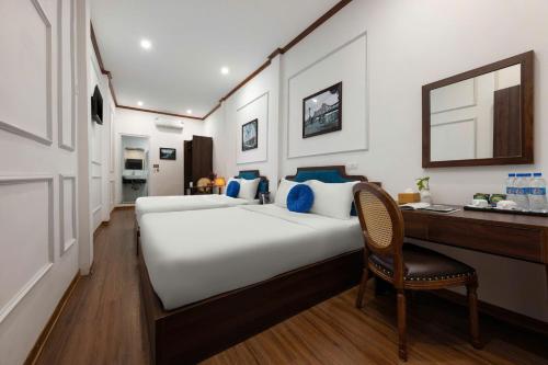 Postel nebo postele na pokoji v ubytování The Ambery Hanoi Boutique Hotel & Travel
