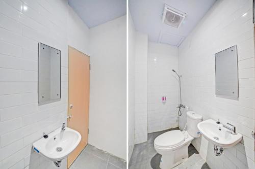 a white bathroom with a toilet and a sink at Hotel O Gamacity Residence in Pulauberayan Dadap