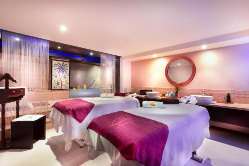 a hotel room with two beds and a mirror at Grand Chennai by GRT Hotels in Chennai