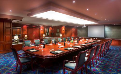 a large conference room with a long table and chairs at Grand Chennai by GRT Hotels in Chennai