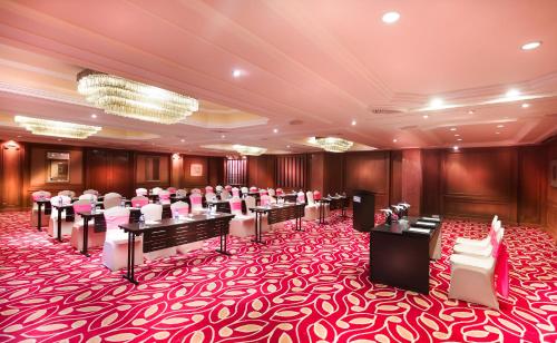 a conference room with a red and white carpet at Grand Chennai by GRT Hotels in Chennai