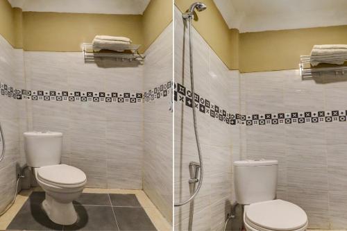 a bathroom with a toilet and a shower at Collection O 90564 Hotel Merangin Syariah in Bangko