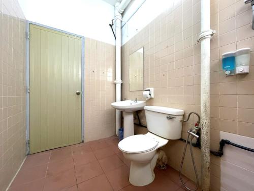 a bathroom with a toilet and a sink at Hotel O Wg Guest House in George Town