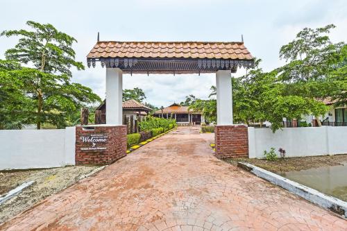 a pavilion at the end of a brick road at Hotel O Jentayu Homestay Pontian in Pontian Kecil
